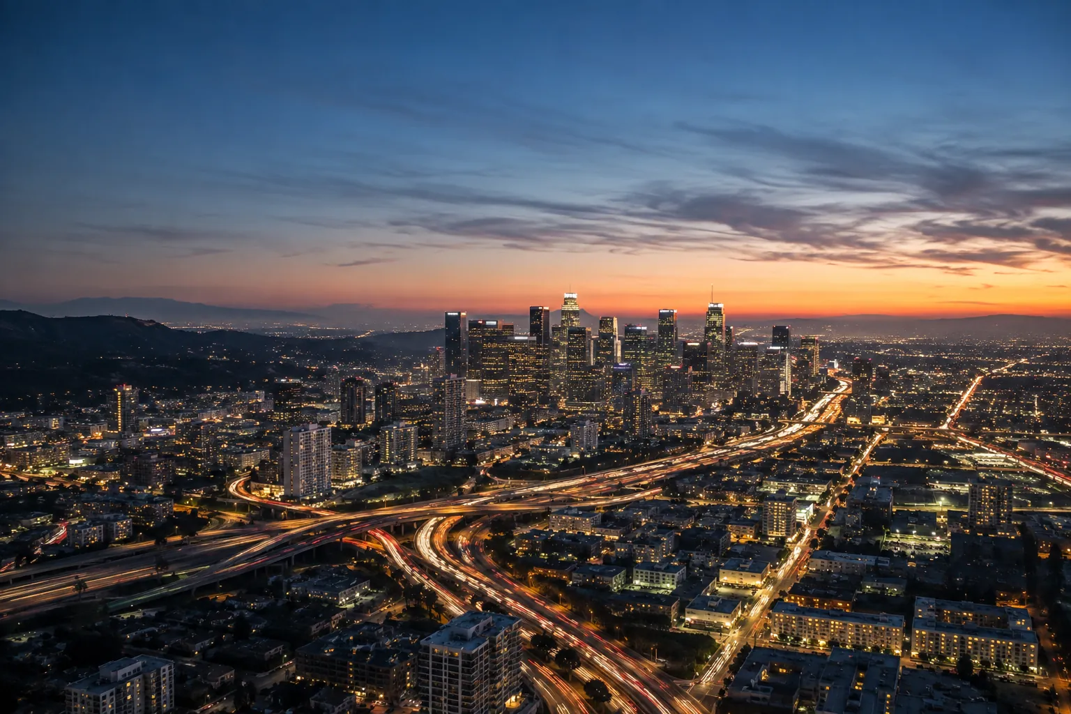 Twilight aerial view of downtown Los Angeles with freeway lights